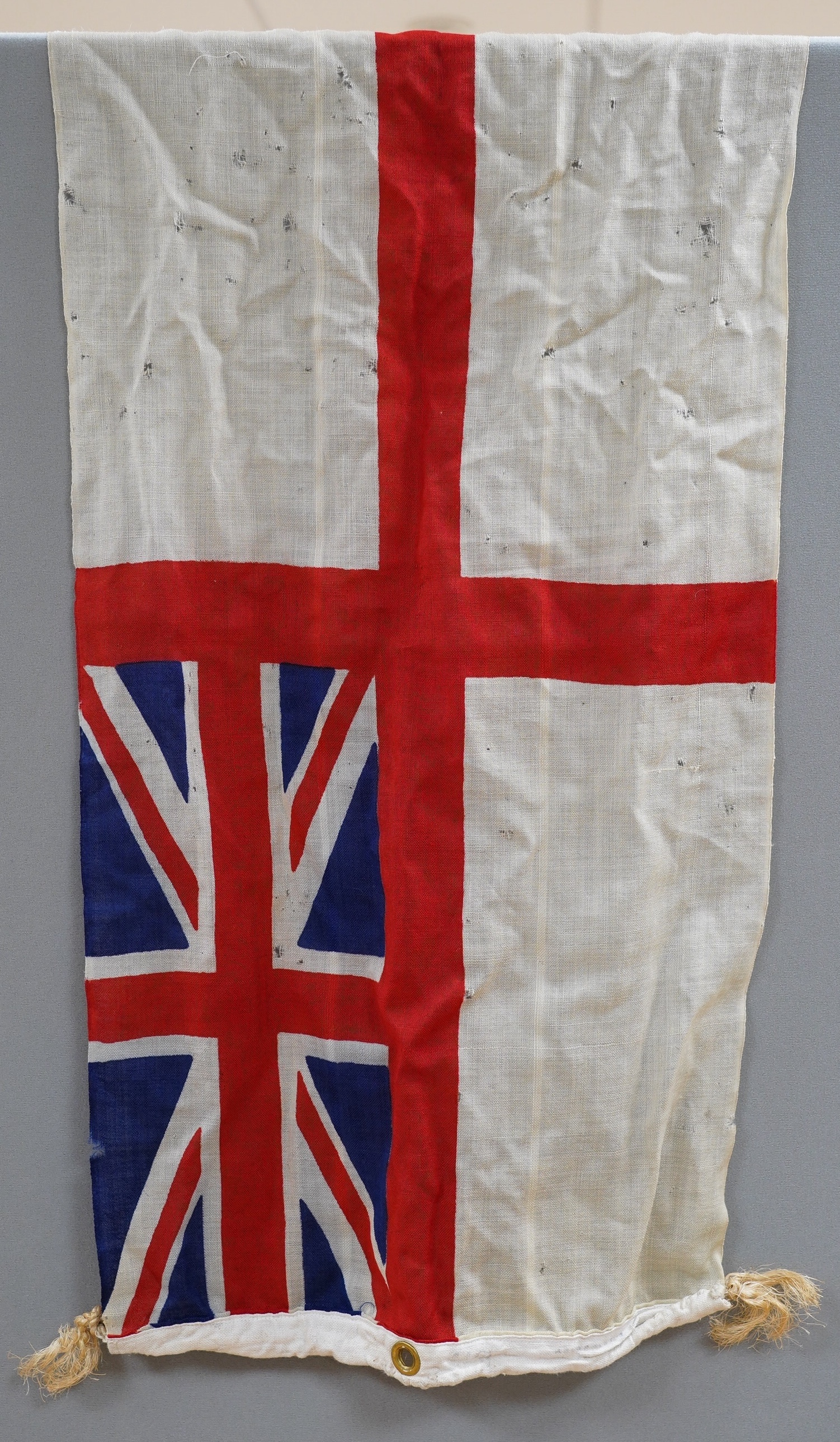 Four early to mid 20th century flags including; two Union Jack flags, a British naval ensign and an American confederate flag, 62 x 86cm. Condition - poor to fair